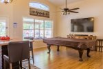 Open family room w/ large HDTV, billiards table, and extra dining space